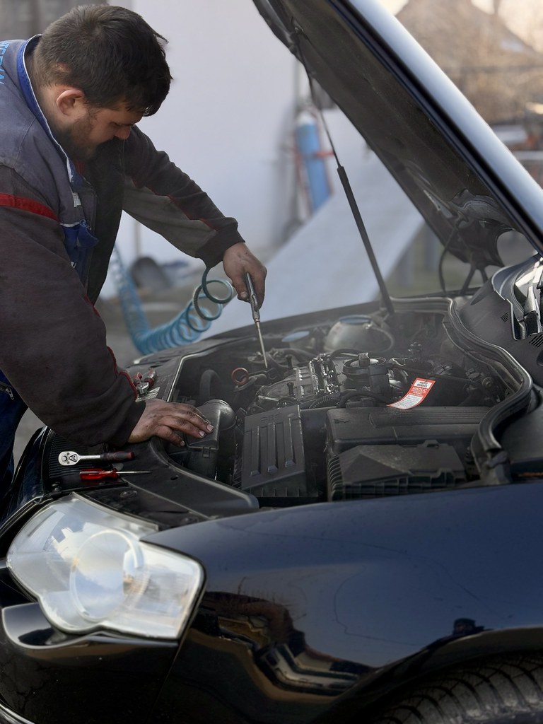 Mechanic working under the bonnet